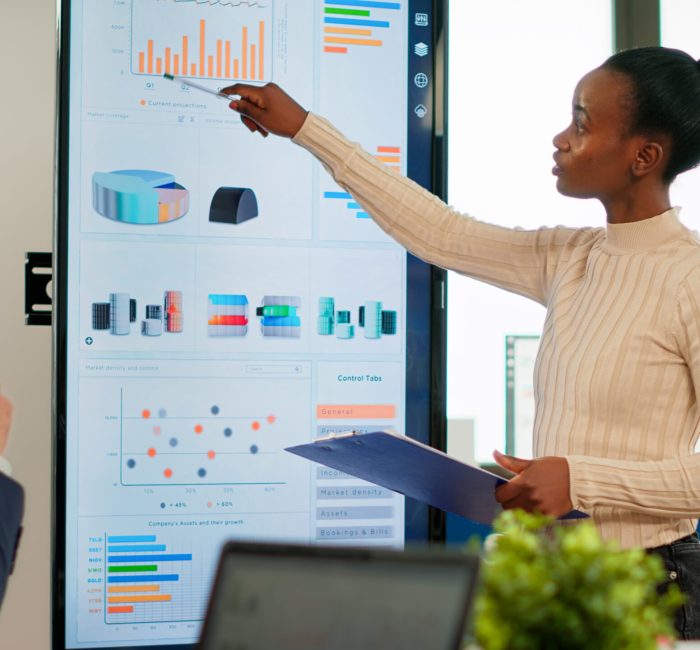 Corporate business people meeting in boardroom, african manager brainstorming with colleagues, discussing strategy, sharing problem, solving ideas collaborating in conference room of company